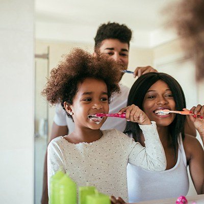 family brushing teeth